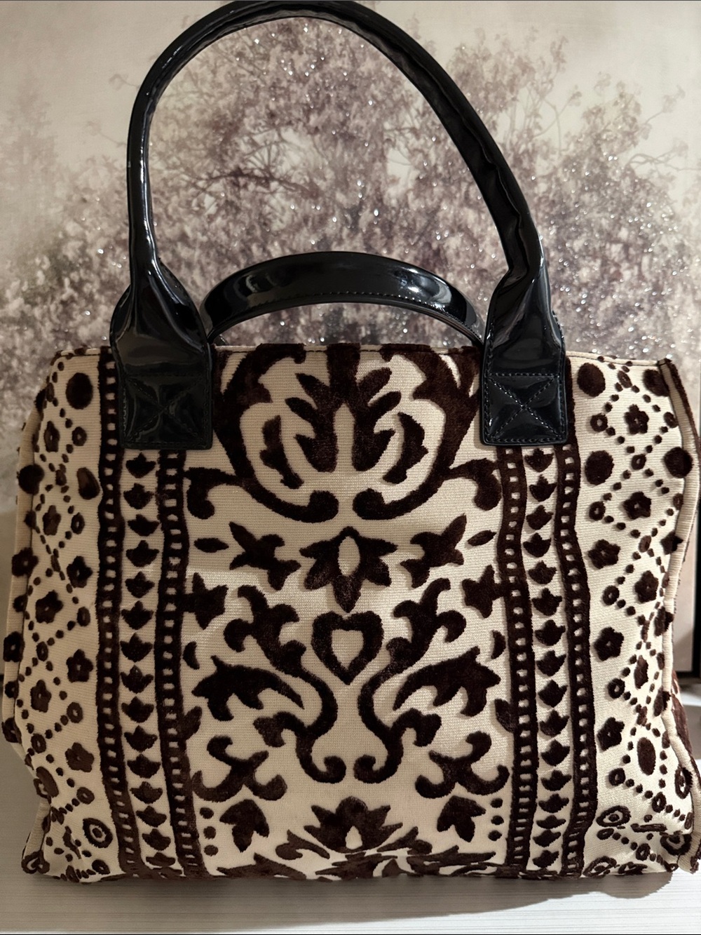 Kate Landry tote features a prominent brown velvet damask$80